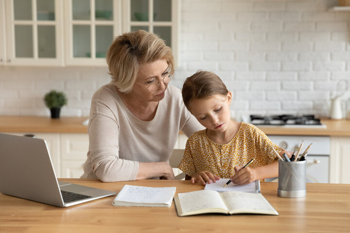 A tutor supporting a young pupil at home